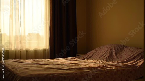 Unmade Bed in a Dark Room.