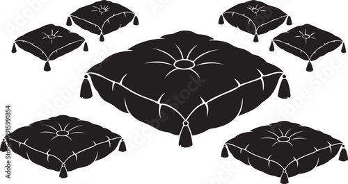 A collection of ornate black cushions with elegant tassels arranged artfully.