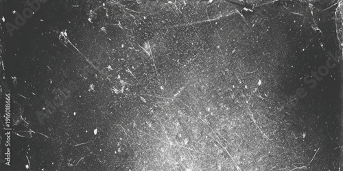 A grainy monochrome abstract image depicting a dark textured background with scattered light spots and lines