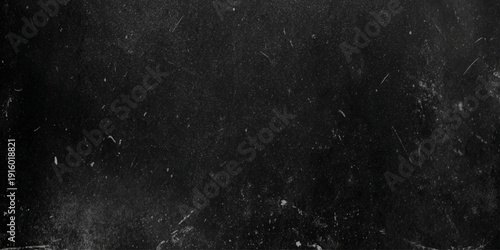 a close up of a black surface with white specks and scratches on it looking like a dirty or worn texture