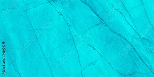 A vibrant turquoise marble texture dominates the frame showcasing natural veining and a smooth polished surface