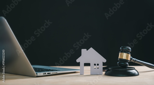 Photos Foreclosure house concept depicting house model, gavel and laptop indicates real