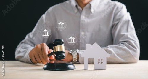 House foreclosure property law concept, person holding gavel on block, small home model, real estate auction sale, mortgage debt, legal court proceedings, bankruptcy division