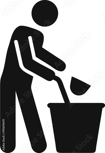 Individual performing a scooping action with a tool into an empty bucket