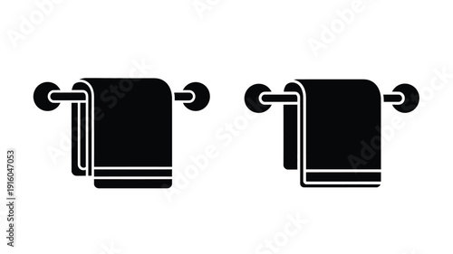 Two folded towels hanging on wall mounts simple depiction silhouette
