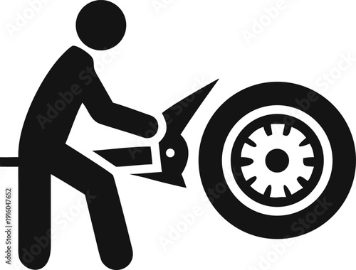 Mechanic Using a Hand Saw to Cut and Process a Car Tire in Workshop