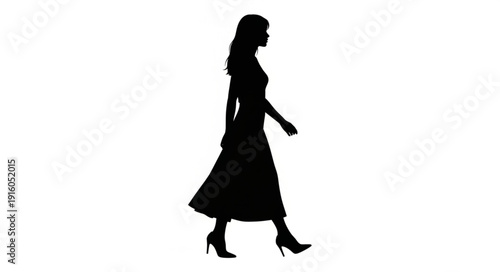 Silhouette of a woman walking in a long dress and high heels.