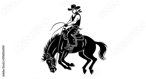 Silhouette of a cowboy riding a bucking horse with a lasso.