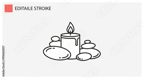 Spa candle and stacked stones for relaxation and wellness.