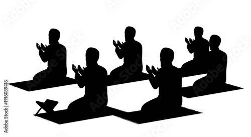 Silhouettes of people kneeling and praying on mats in a group setting
