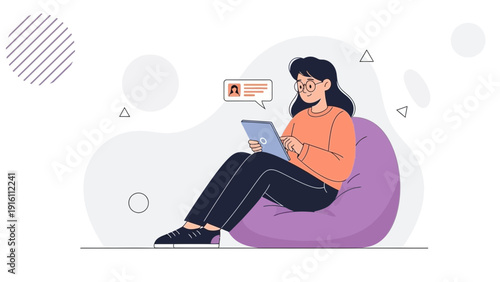 Woman using tablet computer while sitting on bean bag chair, communication concept