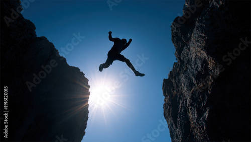 Silhouette Of Brave Man Jumping Across Cliff At Sunset Symbolizing Risk Freedom And Success