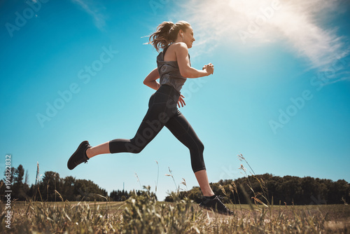 Obraz na płótnie Runner, smile and earphones with woman outdoor for workout playlist, sports and health