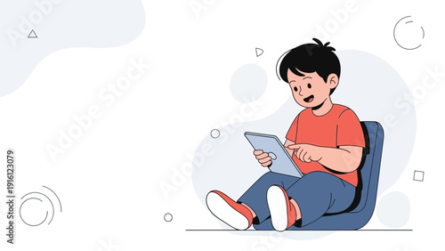 Young boy happily using a tablet computer, sitting on a beanbag chair.