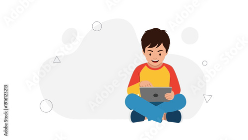 Young boy sitting cross-legged, happily using a tablet computer with a light gray background.