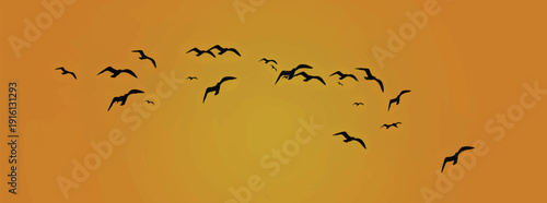 Silhouettes of flock of birds flying against the sky
