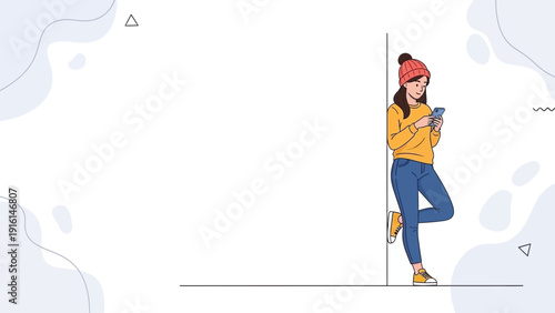 Young woman in beanie and jeans using smartphone, leaning against wall