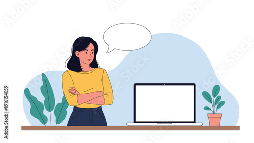 Professional young woman in a yellow sweater standing with arms crossed next to a laptop and a blank speech bubble on a desk.