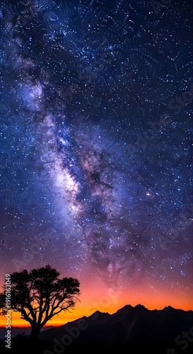 Breathtaking starry night sky over majestic mountain range at sunset