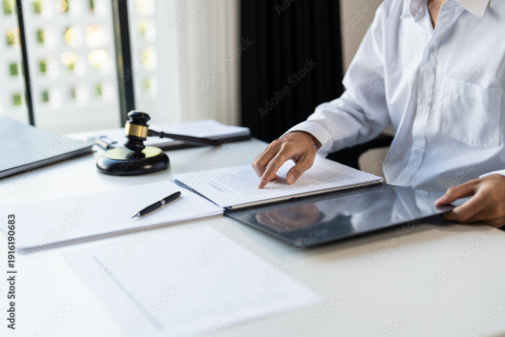 Fototapeta premium Lawyer businessman working&nbsp;with lawbook in office&nbsp;or courtroom Legal counsel with gavel and legal law. justice and lawyer concept Judge gavel hammer on Lawyer desk.