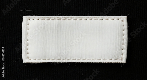 Wallpaper Mural Blank white rectangular fabric clothing label sewn on black textile background, close-up Torontodigital.ca