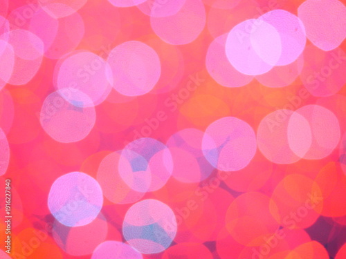 Abstract Bokeh from indoor lighting, Pink with red with orange with gold and yellow circles colored surface, Night city light background for celebration of christmas and holiday season