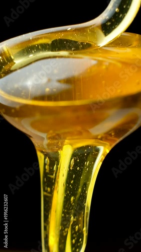 Cinematic food macro, liquid honey movement and texture on black.