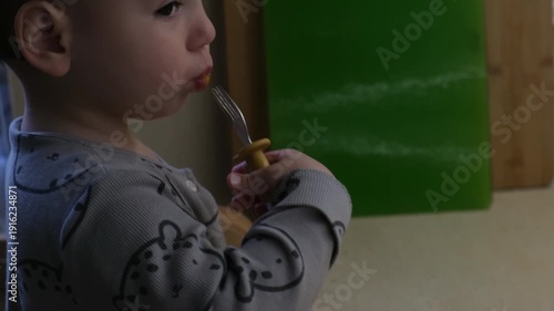Toddler Eating with Fork in Pajamas