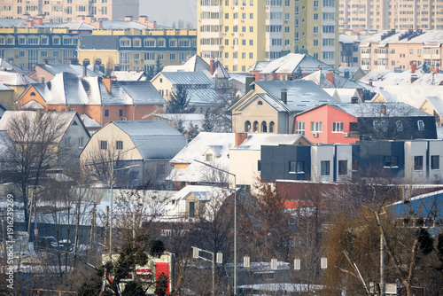 Quiet winter morning in a cozy neighborhood with snow-covered roofs