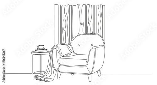 Cozy armchair with a small side table and a cup of tea.