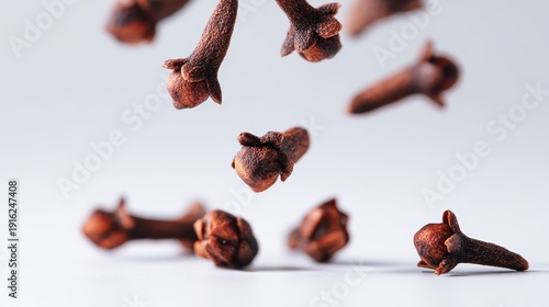 Falling whole cloves isolated on a pure white background