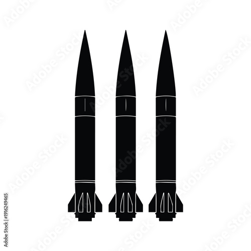 Three sleek black missiles standing upright in a row on launchpad