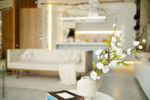Fotografie Bright, minimalist living room with large windows, modern vase, and comfortable sofas