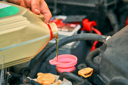 Wallpaper Mural Worker pouring petroleum oil into auto engine Torontodigital.ca