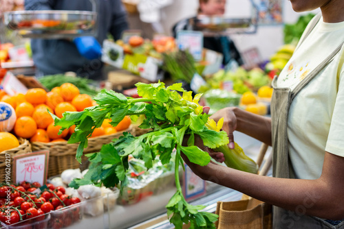 Mid section of woman buying groceries in a market hall