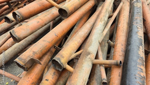 Fotografie Rusty scrap metal pipes for recycling in a junkyard