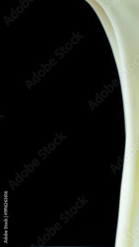 Organic Yogurt Flowing Down Macro Drops on Black Background