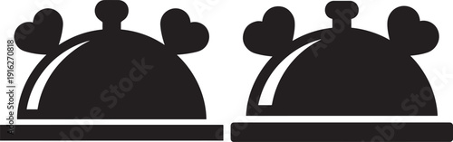 Stylized black icons of two serving domes with heart-shaped handles, suggesting romance, special meals, or fine dining with a loving touch.