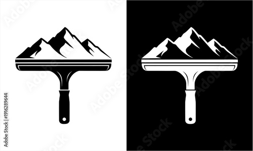 Mountain peaks silhouette on top of a window squeegee tool.