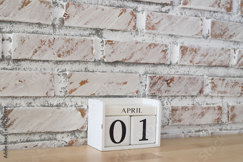 April 1st. Image of april 1 wooden color calendar on white brick wall background. empty space for text. 