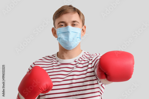 Young man in medical mask a...