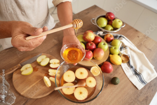 Mature man with honey makin...