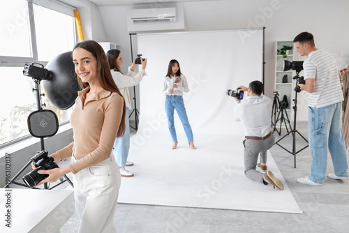 Female photographer with ca...