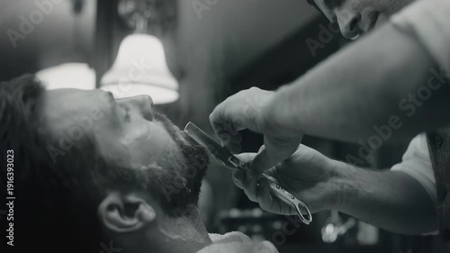Professional retro barber shaving male client beard with straight razor in vintage black and white barbershop for classic grooming fashion and gentleman masculinity style concept