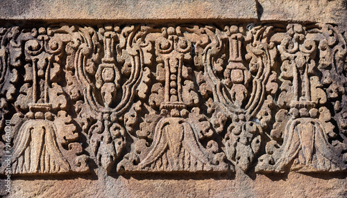 Obraz na płótnie Intricate stone carving floral pattern bas relief pink sandstone ancient Khmer a
