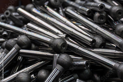 Bright steel shafts and ball joints machined with precise tolerances from an industrial production line.