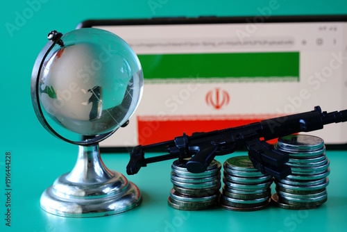 Wallpaper Mural A globe statuette with coins and an Iranian flag with weapons on a green background. Torontodigital.ca