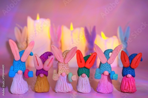 Wallpaper Mural Toy Easter gnomes with plasticine ears on a background of burning candles. Torontodigital.ca
