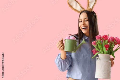 Young woman in bunny ears w...