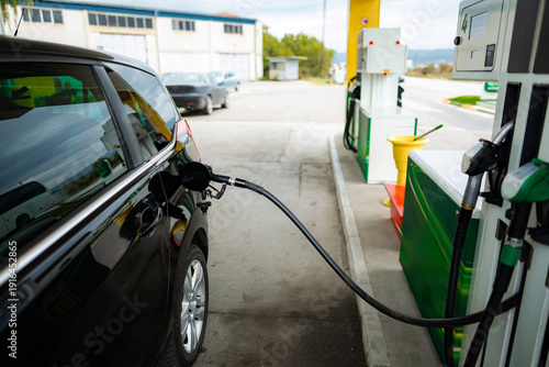 Wallpaper Mural Car refueling at gas station pump with fuel nozzle Torontodigital.ca